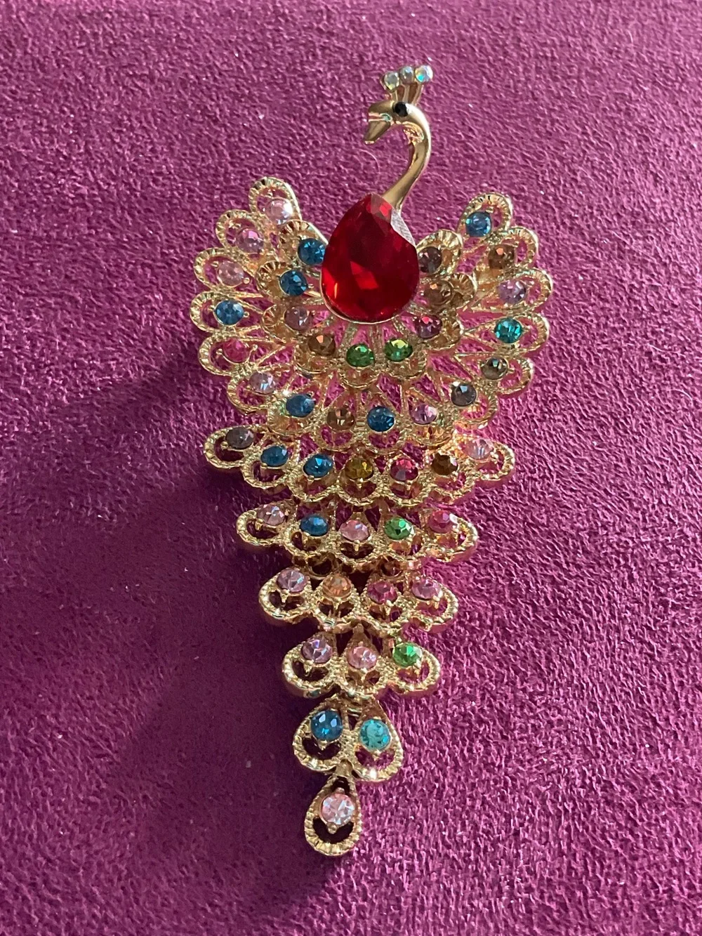Elegant Gold-Tone Peacock Brooch with Red and Multicolor Crystals  4 1/4” long.